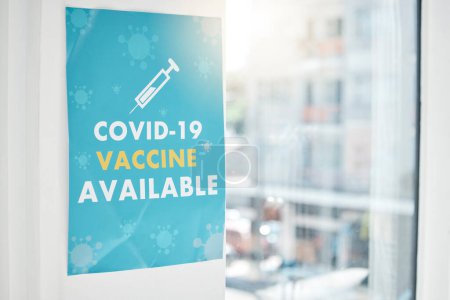 Poster, covid and vaccine with a sign on a wall in an empty hospital or clinic for healthcare and medication. Advert, corona virus and vaccination with a message in a health center for treatment.
