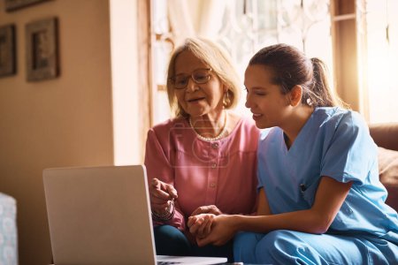 Photo for Showing her how easy it is to stay connected. a female nurse and a senior woman using a laptop together - Royalty Free Image