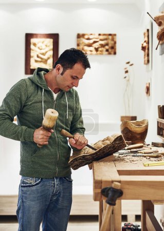 Photo for Traditional art is the perfect antidote for stress. an artist carving something out of wood - Royalty Free Image