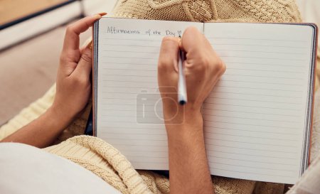 Hands of woman relax, writing in notebook mockup for morning routine on living room sofa. Affirmations, personal goals and book of calm life thoughts or young girl creative thinking journal on couch.