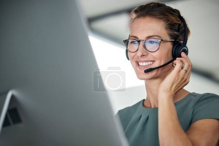Customer service, woman and happy call center agent giving advice online using a headset. Operator, telemarketing and support with hotline consultant working for contact us help or arm consulting.