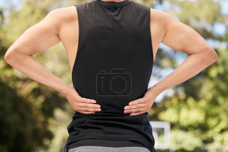 Photo for Athlete with back pain, injury or accident from sports match or training on an outdoor court. Fitness, basketball and man with muscle sprain, hurt spine or medical emergency after workout or exercise. - Royalty Free Image