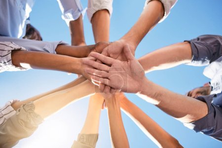 Low angle, hands and circle in success, solidarity or support team building, teamwork collaboration or diversity celebration. Men, women and friends in community huddle for business motivation goals.
