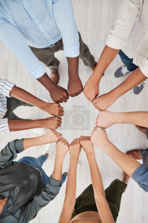 Photo for Team building, fist and hands in support of motivation circle by colleagues show community, trust and diversity above. Hand, people and collaboration with team in huddle for goal, mission and vision. - Royalty Free Image