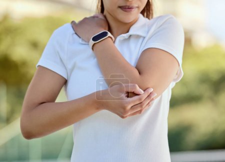 Tennis elbow, sports and a woman with injury, fitness and training game on court. Workout, sport exercise and healthcare, tennis player girl with arm pain or inflammation, accident at outdoor match