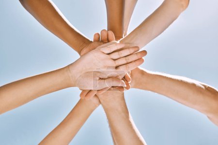 Photo for Below hands stack, group motivation support and trust together outdoor with blue sky. Team hand pile, teamwork vision and solidarity unity friends for community collaboration for people in diversity. - Royalty Free Image