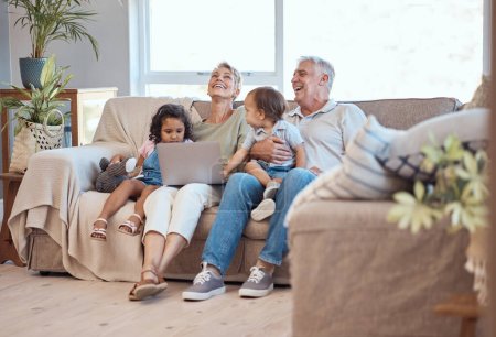 Photo for Happy, family and laptop on the sofa with children and grandparents on home sofa. Senior man and woman relax online with their adopted grandchildren while watching funny movie, streaming or cartoon. - Royalty Free Image