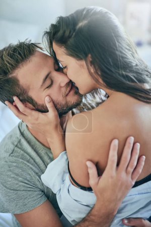 You make me weak at the knees. a young couple sharing an intimate moment in their bedroom magic mug #620662470