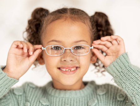 Child, glasses and eye care for vision, focus and eyesight of girl with a smile and happy about optics decision and lens frame choice. Portrait of kid at optometry store for eye health and care.