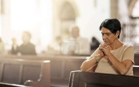 Seniorin betet in der Kirche, verehrt und vertraut Gott, dem Gebet oder dem spirituellen Respekt. Christinnen loben in heiligem Tempel der Religion, des Glaubens und der sonntäglichen Gemeinde für Bibelgottesdienst, Frieden und Gnade.
