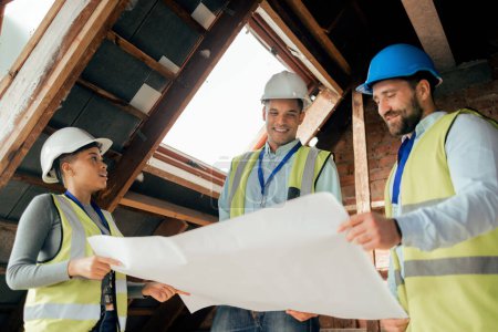 Photo for Teamwork, planning and construction workers with blueprint in building looking at engineering design, floorplan and illustration. Diversity, collaboration and engineers working at construction site. - Royalty Free Image