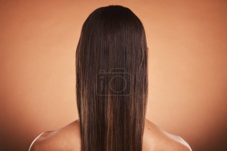 Photo for Brunette woman, shine and hair care, beauty salon, balayage and hair dye, color cosmetics and wig extension on studio orange background. Back of head, scalp and long hair style with smooth texture. - Royalty Free Image