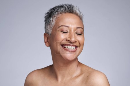 Photo for Happy senior model, beauty and makeup face for cosmetics, health and skincare by studio backdrop. Elderly black woman, skin wellness and radiant cosmetic glow, anti aging and smile by grey background. - Royalty Free Image