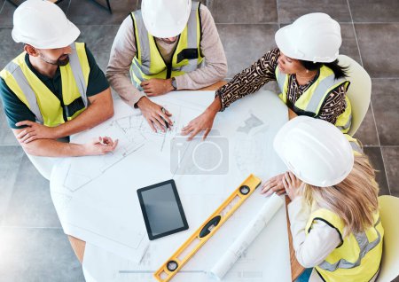 Photo for Above, blueprint and architects planning design of house during meeting for construction and building project with tech. Teamwork, industrial and engineers in collaboration for renovation on paper. - Royalty Free Image
