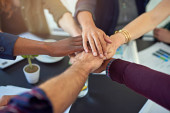 Motivating and strengthening partnerships. Closeup shot of a group of businesspeople joining their hands together in unity Poster #620774916