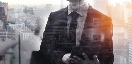 Photo for Conquering the concrete jungle. Multiple exposure shot of a businessman superimposed on a cityscape - Royalty Free Image