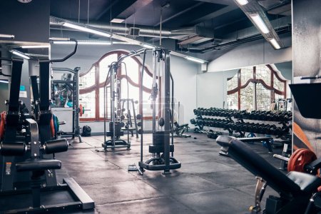 Photo for Empty gym, backgrounds and exercise building for sports, training and fitness, wellness and weightlifting. Health club interior space, recreation center and room with bodybuilding workout machines. - Royalty Free Image