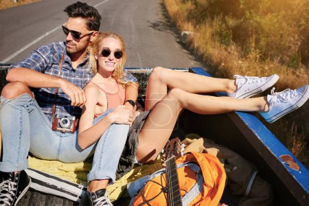 Photo for Theres no end to the adventures that we can have. a young couple relaxing on the back of a pickup truck while on a road trip - Royalty Free Image
