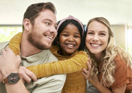 Photo for Family, adoption and parents hug child, love and happiness with child care portrait, relax at family home. Happy, bonding and interracial people with foster care and mother, father with kid - Royalty Free Image