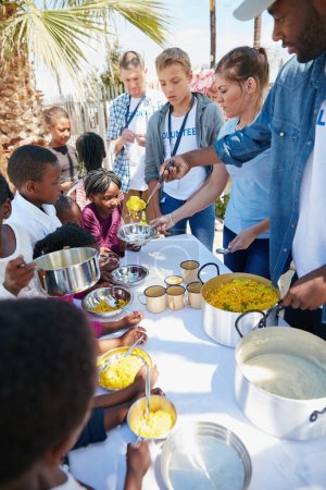 Photo for All hands on deck. children getting fed at a food outreach - Royalty Free Image