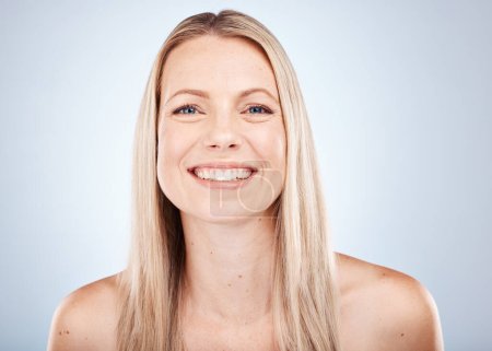 Photo for Hair care, cosmetics and portrait of a woman with a smile against a grey studio background. Skincare, wellness and face of a happy model with straight hair from the hairdresser with clean shine. - Royalty Free Image