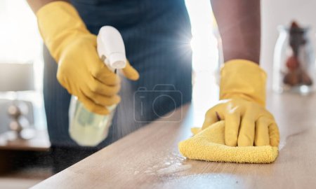 Photo for Black man hands, spray bottle or cleaning cloth for wooden table or desk in house living room, home or office building. Zoom, cleaner or maid service with fabric product for bacteria hygiene wellness. - Royalty Free Image