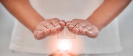 Hands, light energy and chakra healing for spa healthcare and luxury wellness. Woman palm, reiki therapy and spiritual aura expert or healthy power balance for calm lifestyle with body wellbeing.