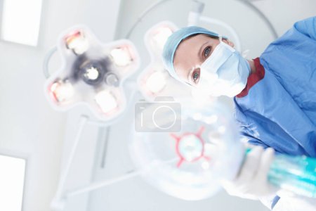 Photo for Just breathe in and out very slowly. Patients view of a medical surgeonnurse putting them under a general anaesthetic - Royalty Free Image