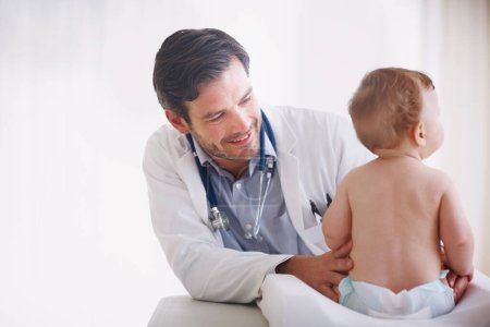 Photo for He really cares about his patients wellbeing. A young male doctor examining an infant girl - Royalty Free Image