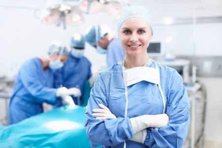 Photo for I love this job. Portrait of a happy female surgeon smiling in an operating theatre - Copyspace - Royalty Free Image