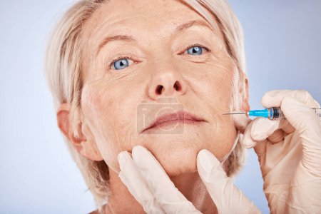 Photo for Botox, senior woman and injection for health, smooth skin and wellness with grey studio background. Plastic surgery, mature female or elderly lady with fine needle, body care facial detox or skincare. - Royalty Free Image