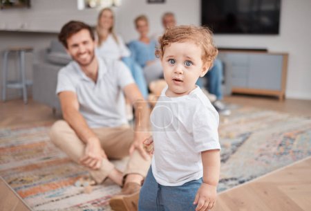 Baby, portrait and play in living room with family, curious and energy, cute and little with dad, mom and grandparents. Boy , mother and father bonding in lounge with grandmother and grandfather.