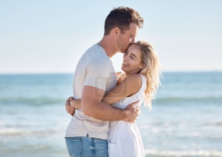 Photo for Love, kiss and happy couple hugging on a beach while on a romantic summer vacation together in Australia. Travel, freedom and young man and woman embracing in nature by the ocean on honeymoon holiday. - Royalty Free Image