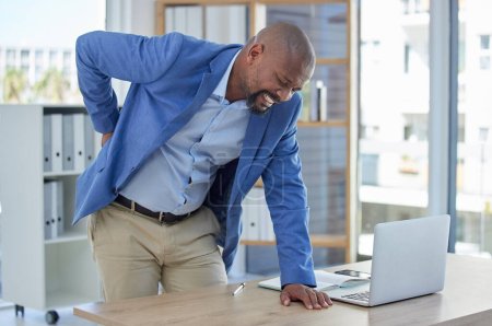 Photo for Back pain, spine and injury with businessman at desk for burnout, muscle and fatigue. Overworked, stress and accident with black man and body ache for exhausted, tired and inflammation problem. - Royalty Free Image