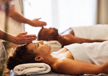 Photo for Black couple, head massage and luxury spa to relax in a room for health, wellness and physical therapy. Man and woman on table for skincare, body care and hospitality while on a vacation. - Royalty Free Image