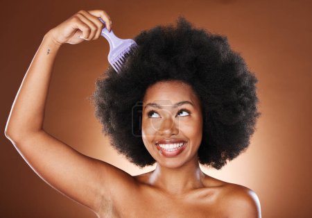 Photo for Beauty, hair care and black woman with afro comb in studio isolated on a brown background. Afro, wellness and happy female model with hair tool for hairstyle, salon treatment or healthy hair - Royalty Free Image
