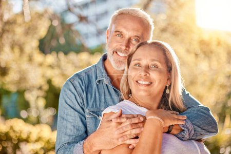 Mature couple, hug and bonding in nature park, environment garden or backyard for interracial marriage anniversary, love or trust. Portrait, smile or happy man and middle aged woman in retirement.