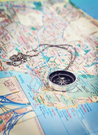 Photo for Time to explore a new city. Closeup shot of a city map with a compass lying on it - Royalty Free Image
