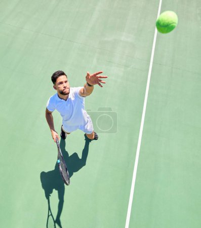 Photo for Top view, tennis player and serving ball on tennis court fitness game, workout match or competition exercise. Sports athlete, man and throwing tennis ball in energy cardio training or health wellness. - Royalty Free Image