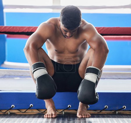 Photo for Boxer, martial arts and man tired and sad after boxing or sports competition mistake, failure or stress, anxiety and depression pre workout. Athlete man worried about exercise or fight at boxing ring. - Royalty Free Image