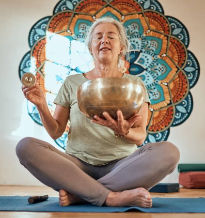 Photo for Senior woman, yoga and meditation in fitness studio for body health and wellness motivation with gold bowl and mandala. Spiritual, energy and balance with mindfulness and zen, healthy and peace - Royalty Free Image