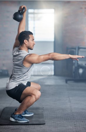 Photo for Fitness, focus and man with weights for strength training, exercise and workout in the gym. Power, strong and athlete training his body for health, motivation for goal and cardio with a squat balance. - Royalty Free Image