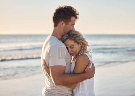 Photo for Dating, love and couple hug at the beach, happy after engagement on holiday, summer vacation and honeymoon. Nature, romance and happy man and woman embracing, hugging and bonding by ocean on weekend. - Royalty Free Image