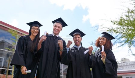 Photo for We did it. Low angle shot of university students on graduation day - Royalty Free Image