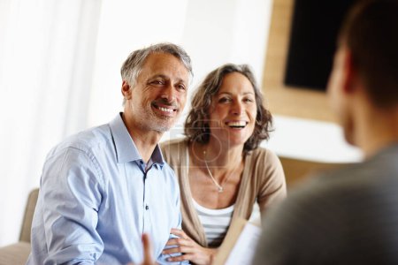 Photo for Thats great news. a happy mature couple talking to an advisor - Royalty Free Image