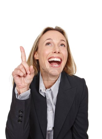 Photo for Shes excited about that. Cropped studio shot of an attractive businesswoman pointing up at copyspace - Royalty Free Image