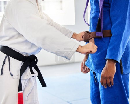 Photo for Belt, student and coach at karate training ready while learning, fitness and motivation in a class. Cardio, health and taekwondo teacher helping a man prepare for martial arts fight at a club. - Royalty Free Image