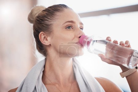 Fitness, workout and exercise woman drinking water bottle for hydration break on cardio run in nature. Training, running and healthy lifestyle of athlete girl with drink for health, hydrate and sport.