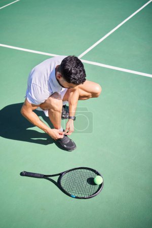 Photo for Tennis, tie and man with shoes on a court for sports training, fitness exercise or cardio workout in summer in Spain. Wellness, athlete or tennis player ready to start playing a game on tennis court. - Royalty Free Image