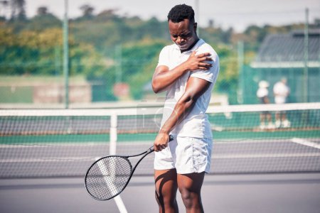 Photo for Sports, tennis and arm pain on court after training, game or match outdoors. Healthcare, tennis player and injured black man or athlete with muscle pain or inflammation after exercise or workout - Royalty Free Image